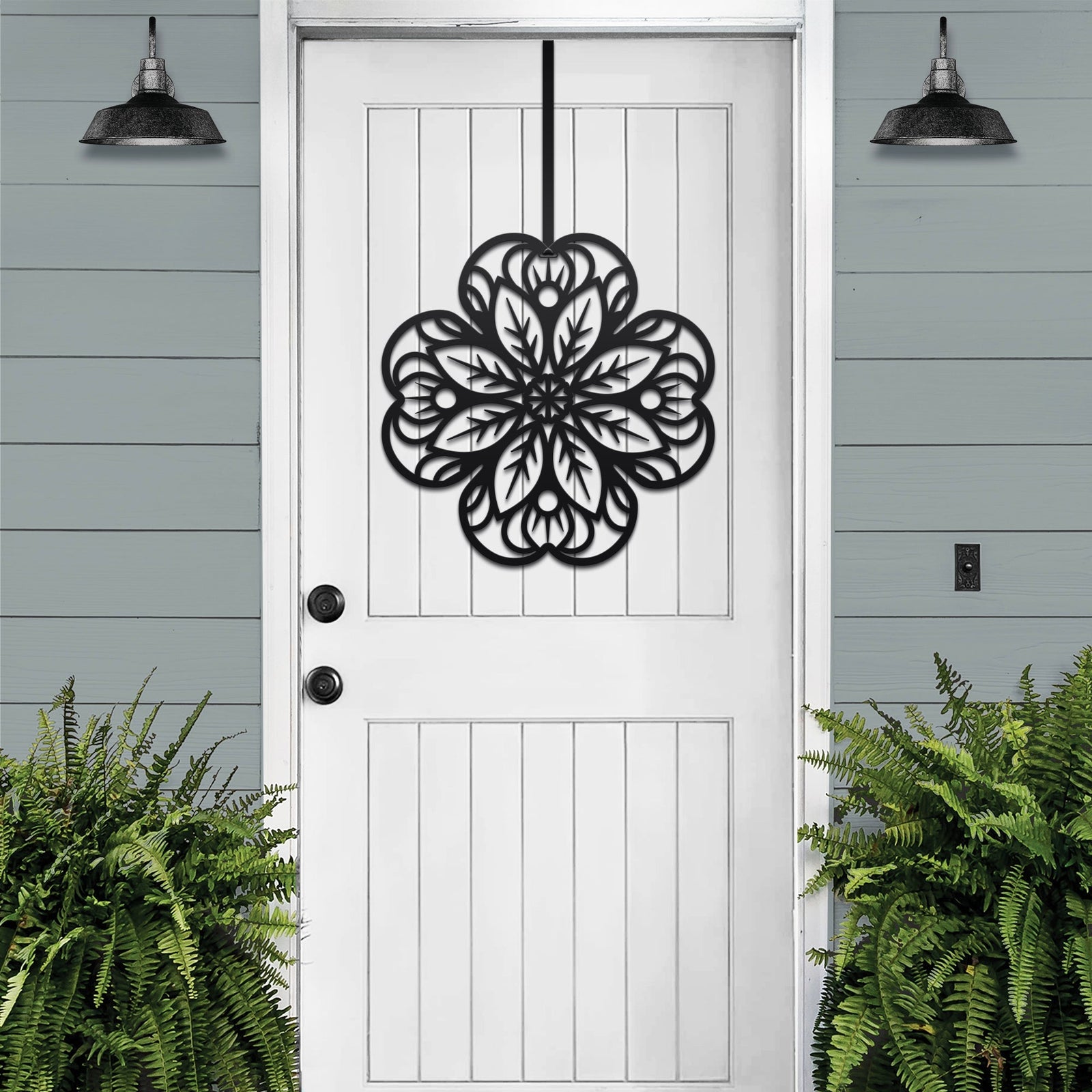Black floral mandala metal wall art on white front door, green plants exterior, custom powder coated farmhouse entry décor, elegant welcome sign design