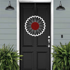 Black front door with circular floral wreath design, white and red metal accent décor, modern farmhouse entryway, curb appeal exterior home styling, custom metal wall art inspiration
