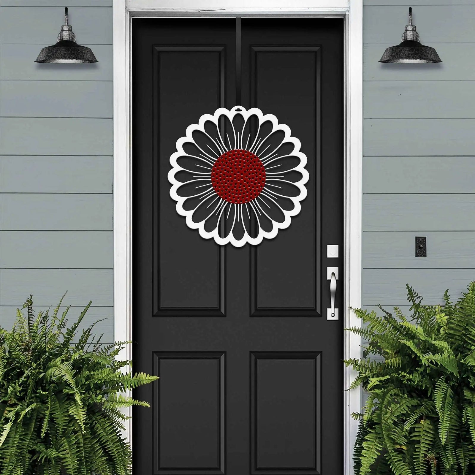 Black front door with circular floral wreath design, white and red metal accent décor, modern farmhouse entryway, curb appeal exterior home styling, custom metal wall art inspiration