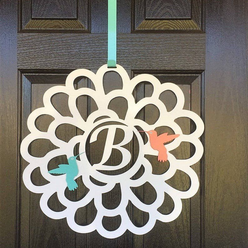HouseSensationsArt metal over-the-door wreath with personalized letter “B” and birds, displayed on wooden door, part of 90-color USA-made collection.