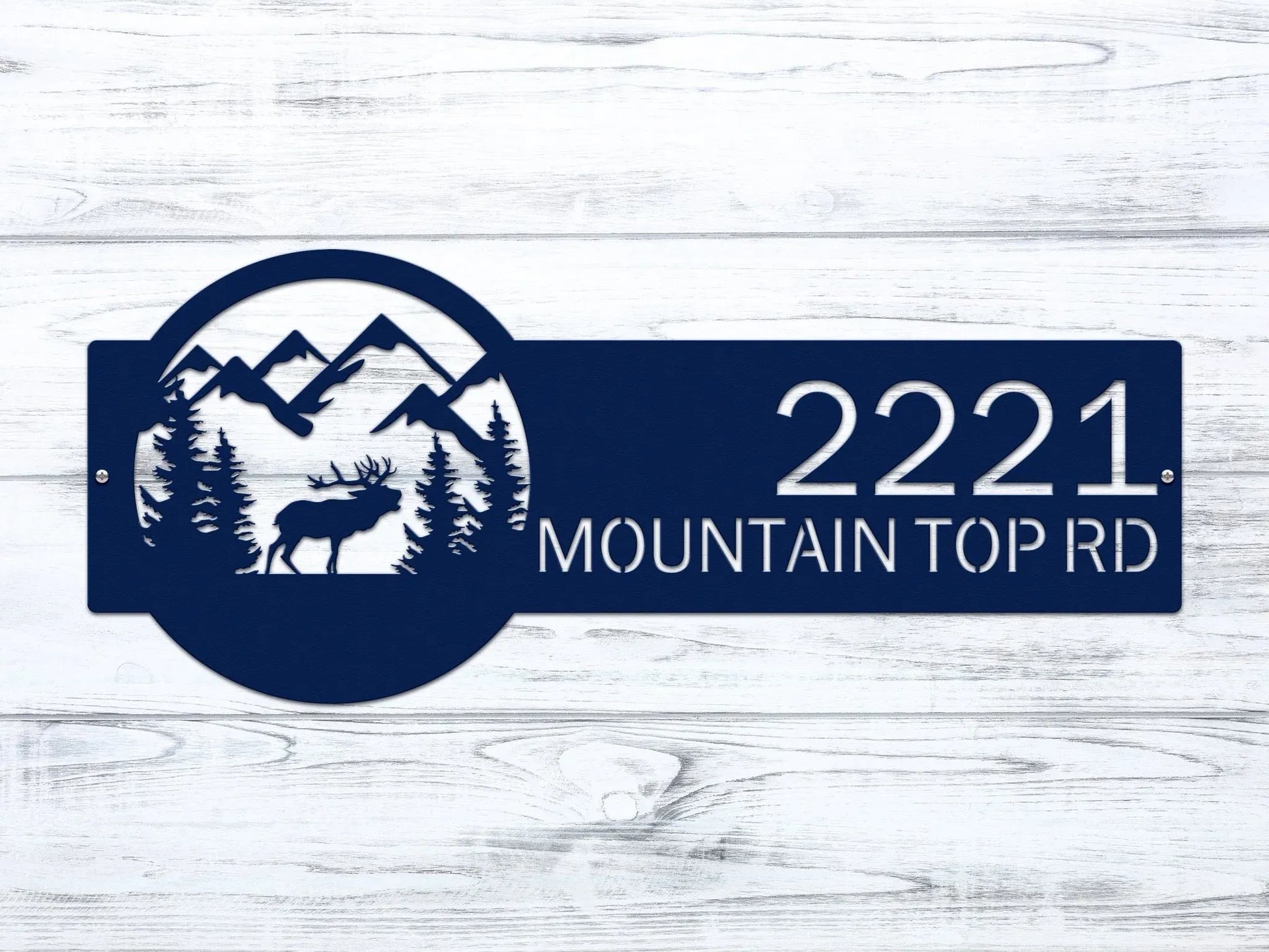 Close-up of navy blue Mountain Elk Address Sign featuring elk, pine trees, and mountain on the right, with house number '2221 Mountain Top Rd' on the left.