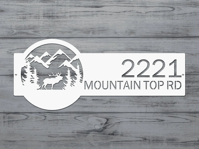 Close-up of White Mountain Elk Address Sign featuring elk, pine trees, and mountain on the right, with house number '2221 Mountain Top Rd' on the left.