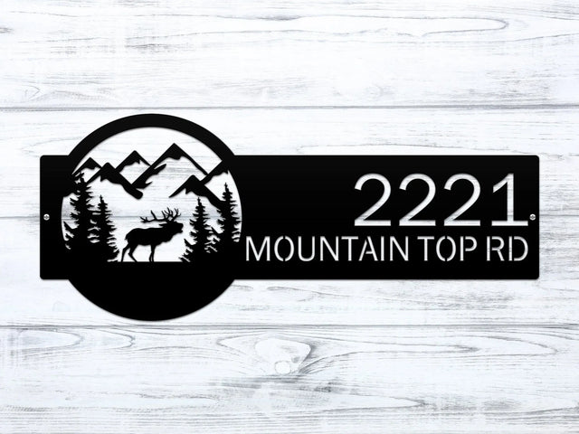 Close-up of Black Mountain Elk Address Sign featuring elk, pine trees, and mountain on the right, with house number '2221 Mountain Top Rd' on the left.