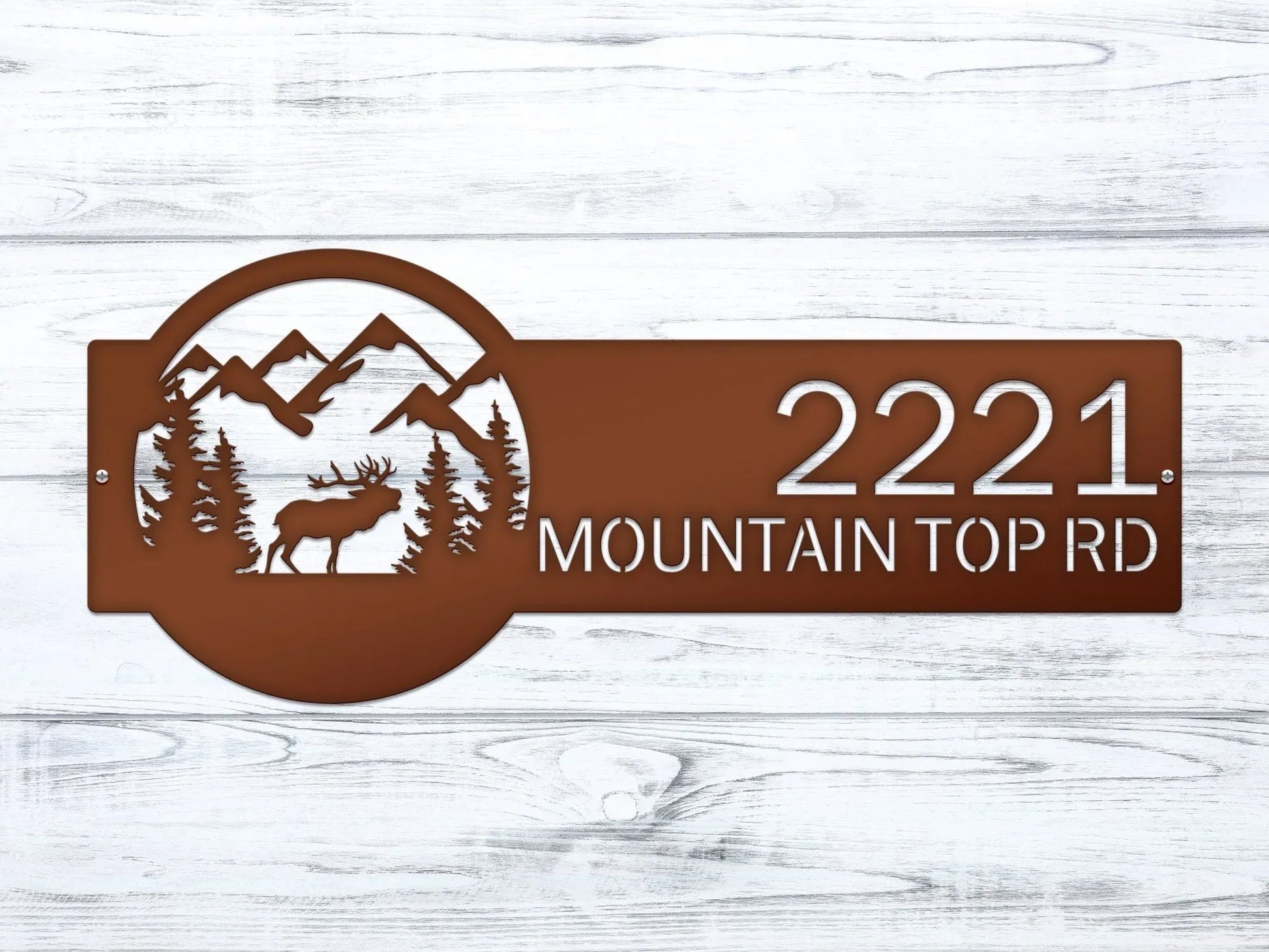 Close-up of Candy copper Mountain Elk Address Sign featuring elk, pine trees, and mountain on the right, with house number '2221 Mountain Top Rd' on the left.
