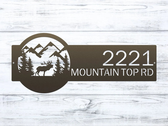 Close-up of Bronze Mountain Elk Address Sign featuring elk, pine trees, and mountain on the right, with house number '2221 Mountain Top Rd' on the left.