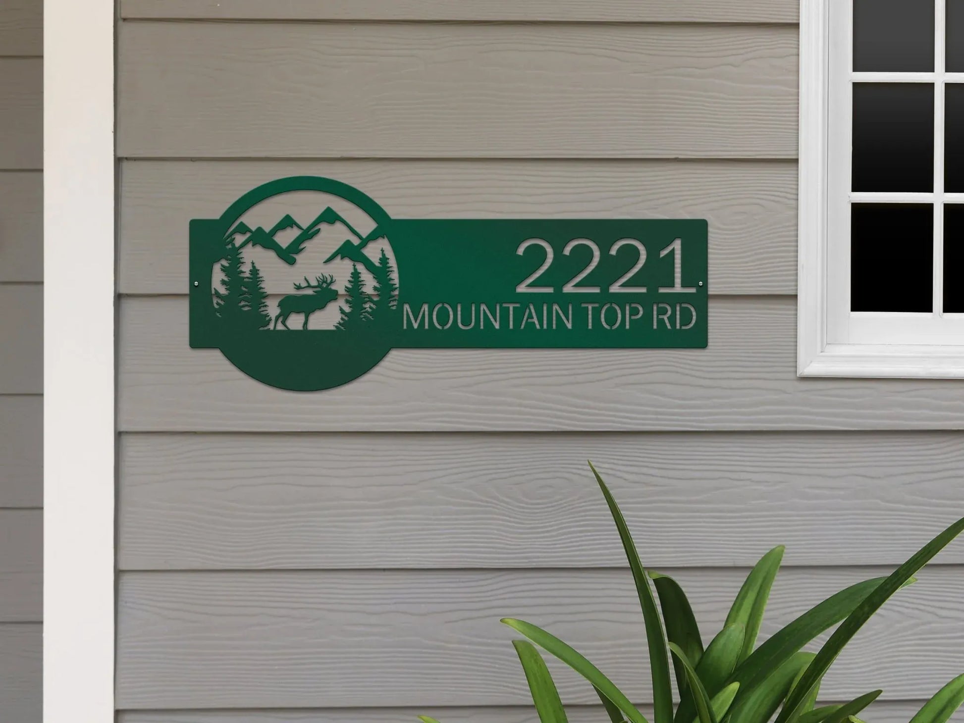 Bionic Green Mountain Elk Address Sign featuring elk, pine trees, and mountain on the right, with house number '2221 Mountain Top Rd' on the left, mounted on the door wall.