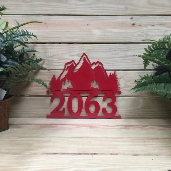 Close-up of Mountain Home Address Sign with number '2063' and mountain design on top, custom metal in deep red color.