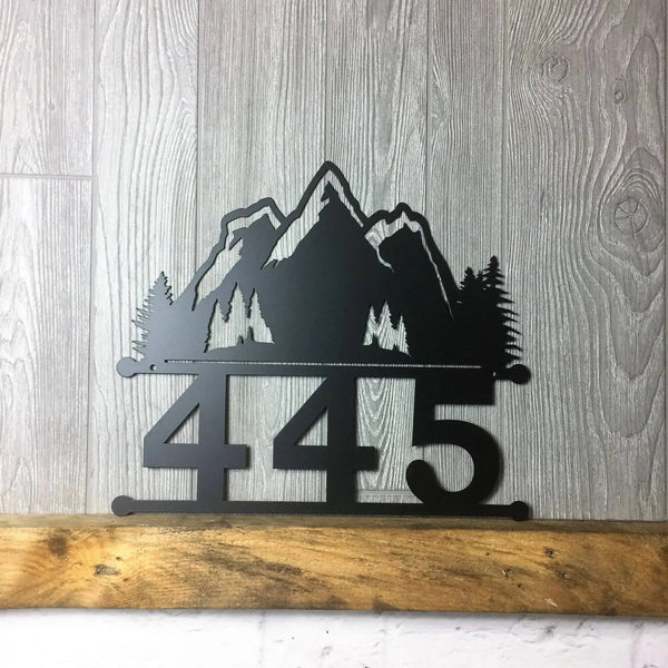 Close-up of Mountain Home Address Sign with number '445' and mountain design on top, custom metal in black color.