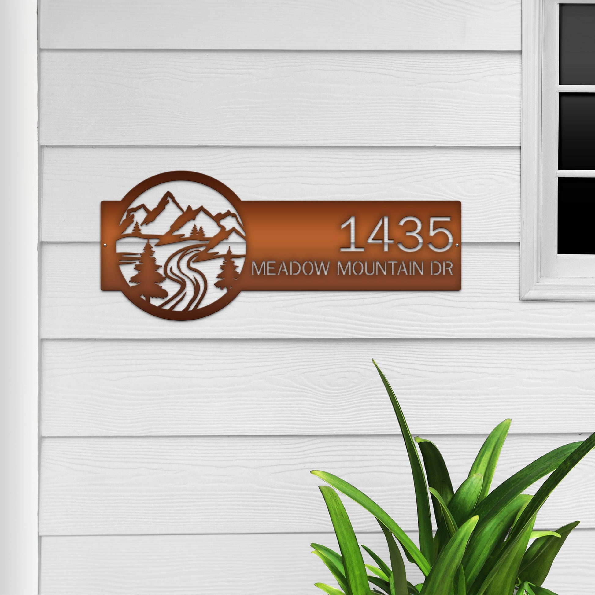 Candy copper Mountain Monogram Address Sign with mountain, pine tree, and rode  on right, house number '1435 Meadow Mountain Dr' left.