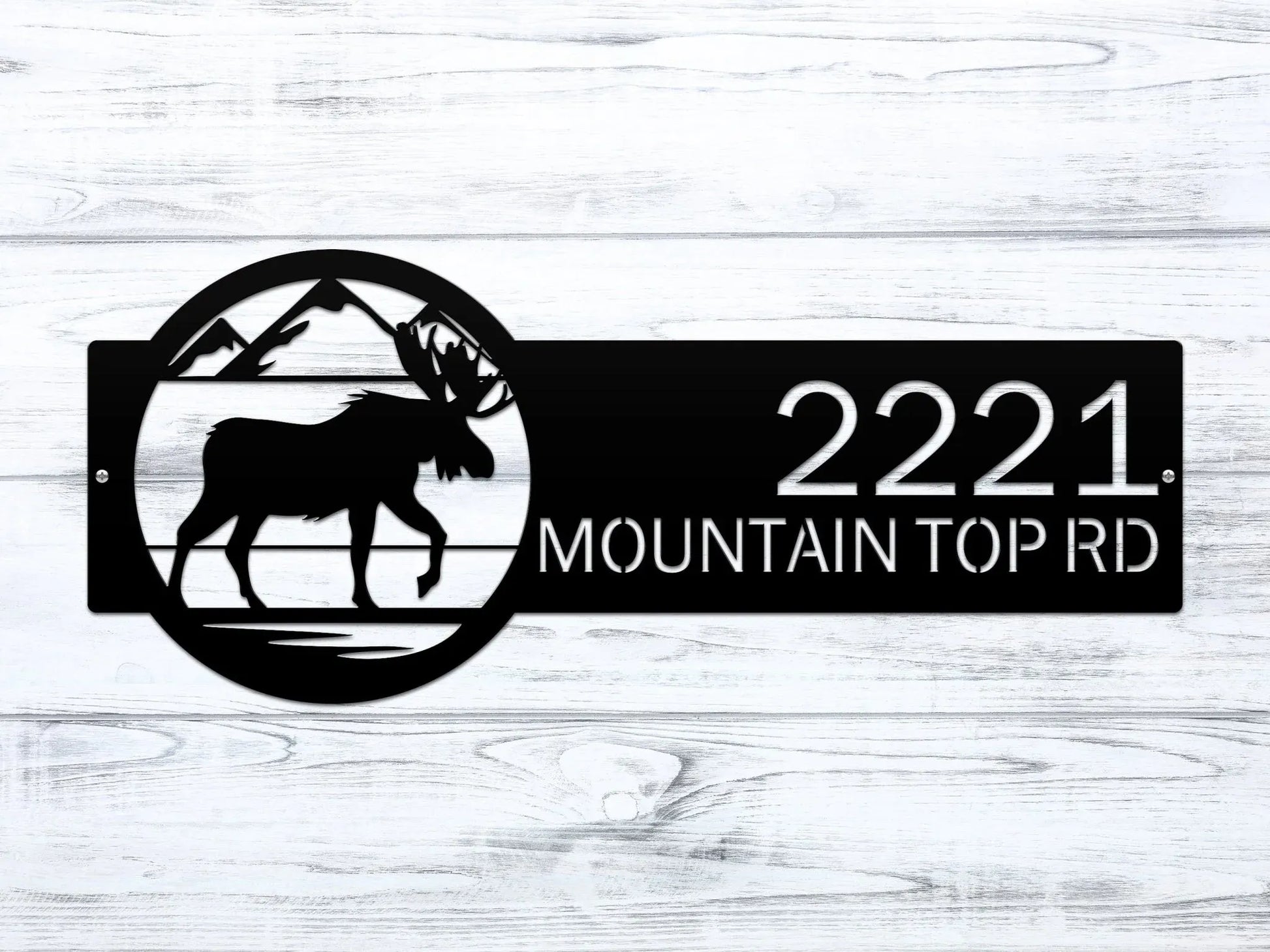 Close-up of black Mountain Moose Address Sign with moose and mountain on right and house number '2221 Mountain Top Rd'.