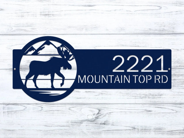 Close-up of navy blue Mountain Moose Address Sign with moose and mountain on right and house number '2221 Mountain Top Rd'.