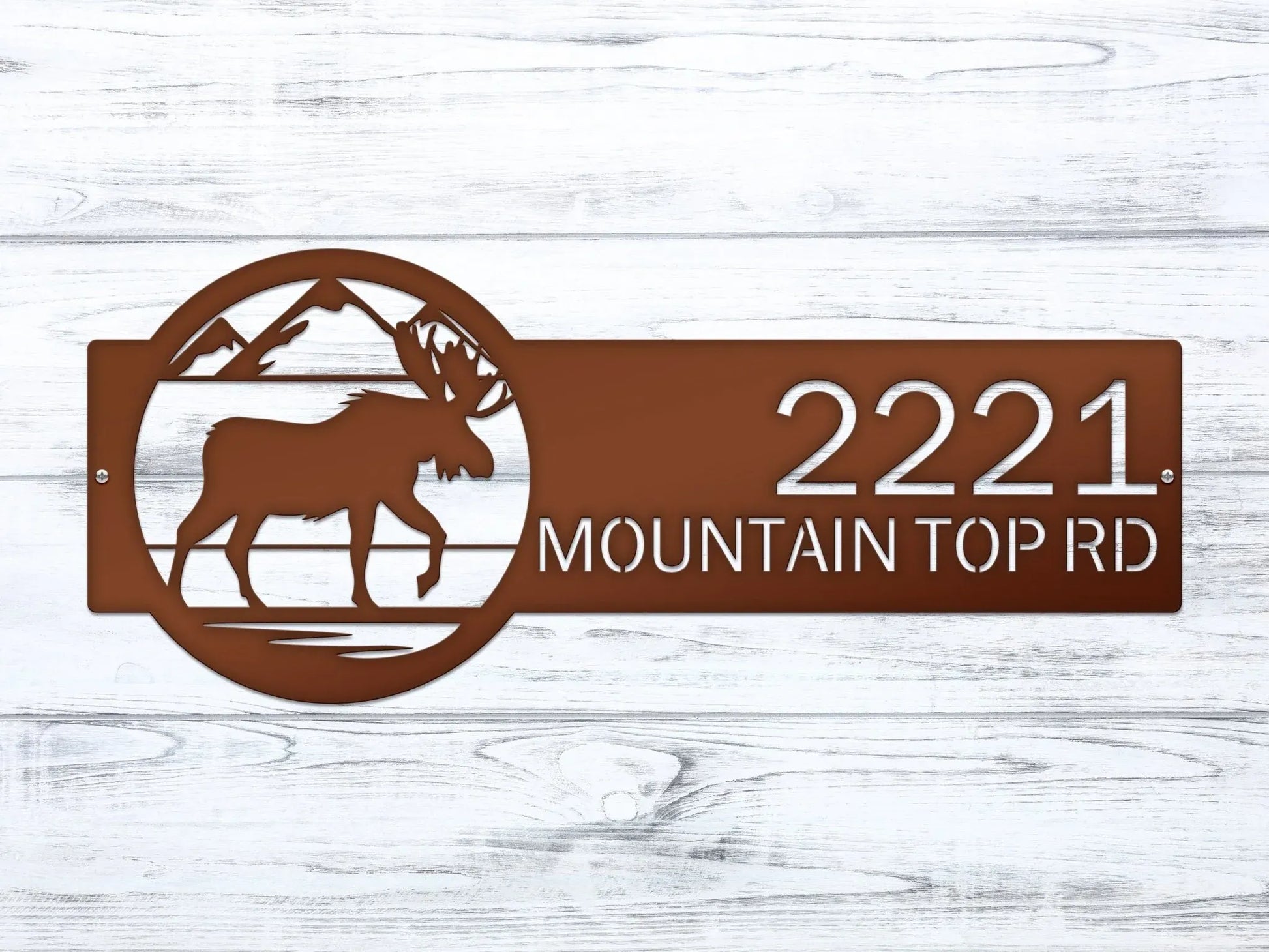 Close-up of candy copper Mountain Moose Address Sign with moose and mountain on right and house number '2221 Mountain Top Rd'.