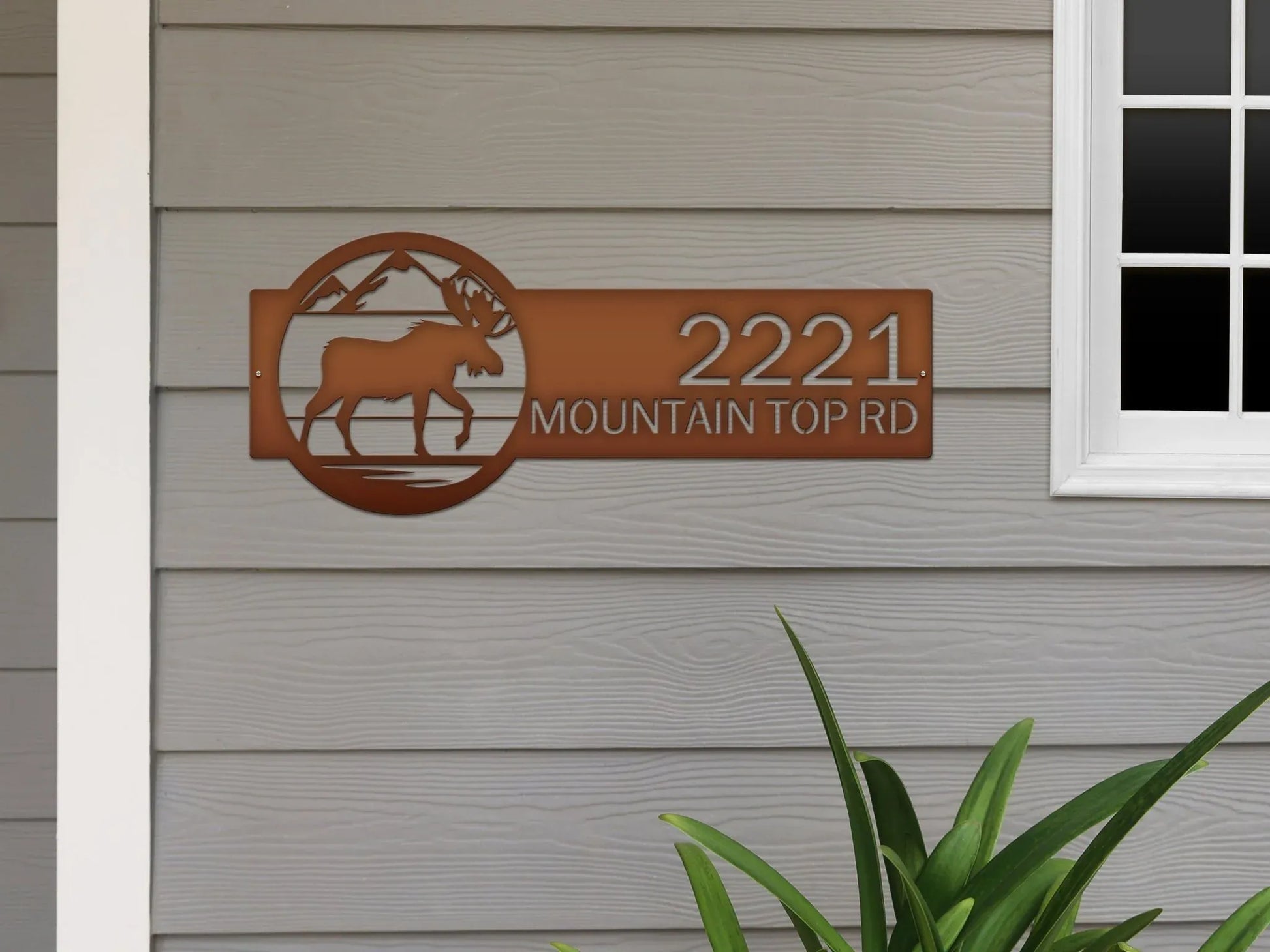 Candy copper Mountain Moose Address Sign with moose and mountain on right and '2221 Mountain Top Rd', mounted on the door wall.