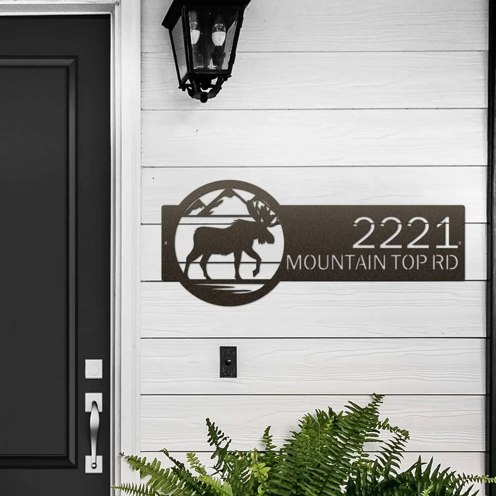 Oil-rubbed bronze Mountain Moose Address Sign with moose and mountain on right and '2221 Mountain Top ', mounted on door wall.Rd