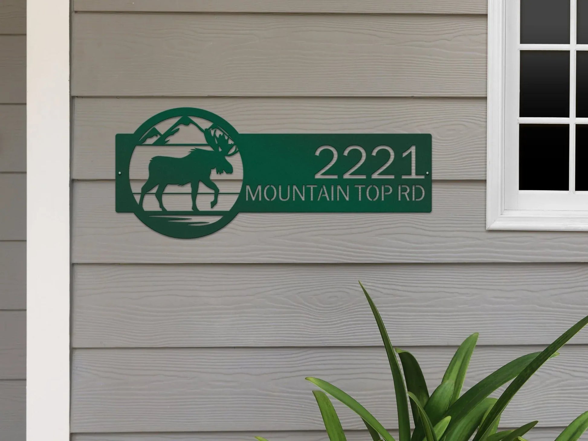 Bionic green Mountain Moose Address Sign with moose and mountain on right and '2221 Mountain Top Rd', mounted on the door wall.