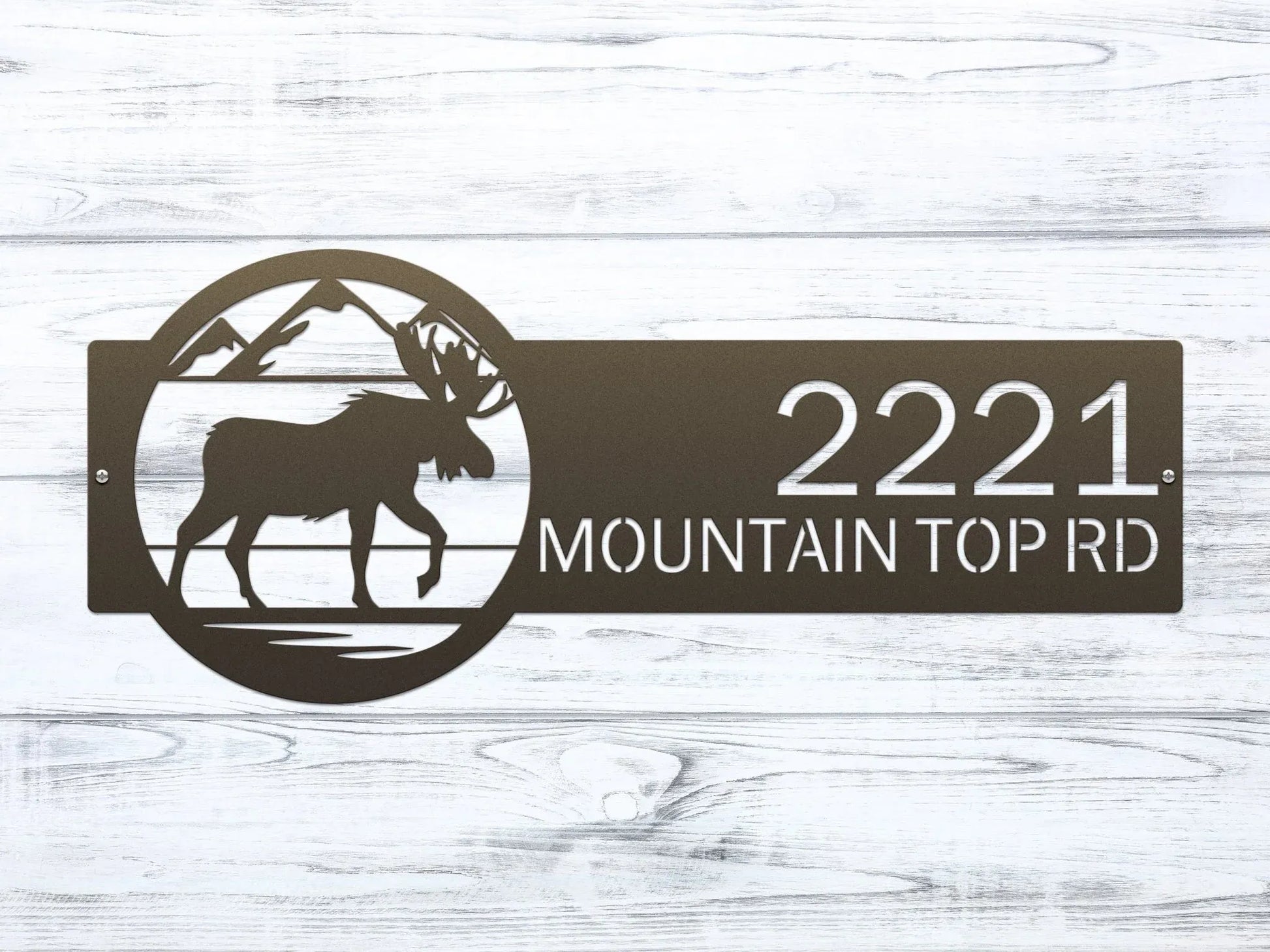 Close-up of bronze Mountain Moose Address Sign with moose and mountain on right and house number '2221 Mountain Top Rd'.
