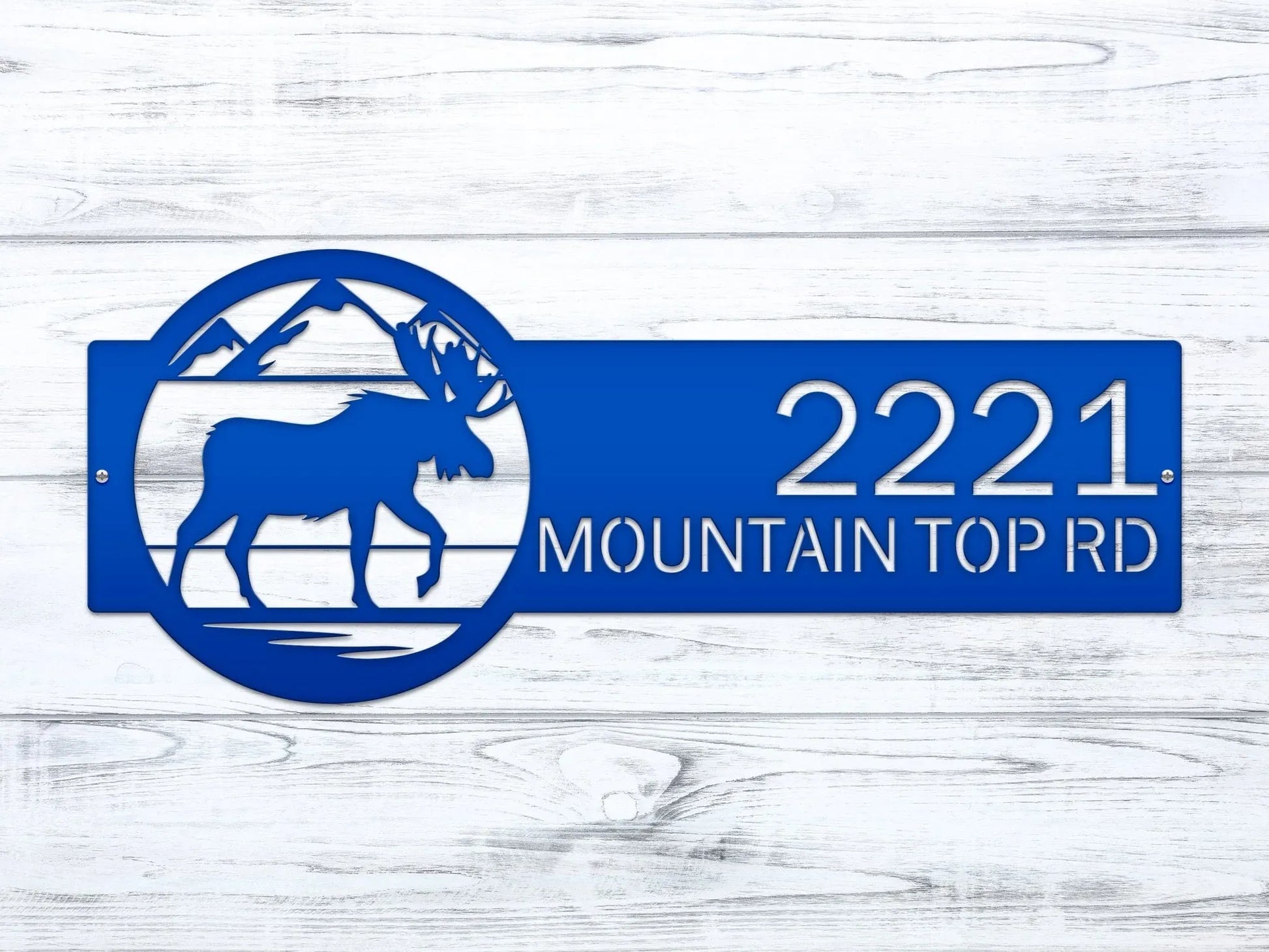 Close-up of bright blue Mountain Moose Address Sign with moose and mountain on right and house number '2221 Mountain Top Rd'.