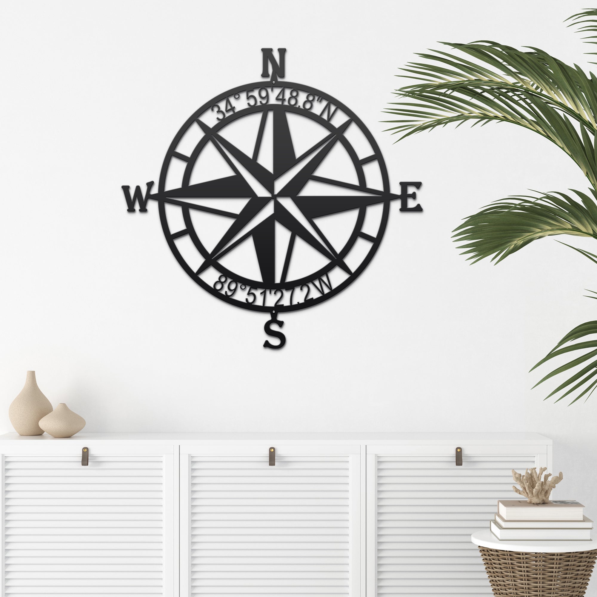 Black nautical compass rose metal wall décor mounted on white wall with decorative accents, coastal-inspired décor, HouseSensationsArt