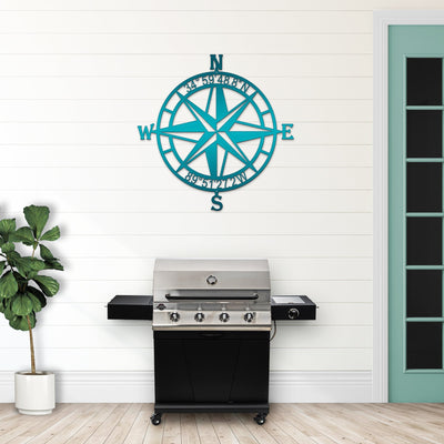 Teal nautical compass rose metal wall art mounted above a grill in outdoor setting, coastal décor, HouseSensationsArt