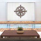 Decorative nautical compass rose metal wall art mounted above pool with wooden deck, coastal outdoor décor, HouseSensationsArt