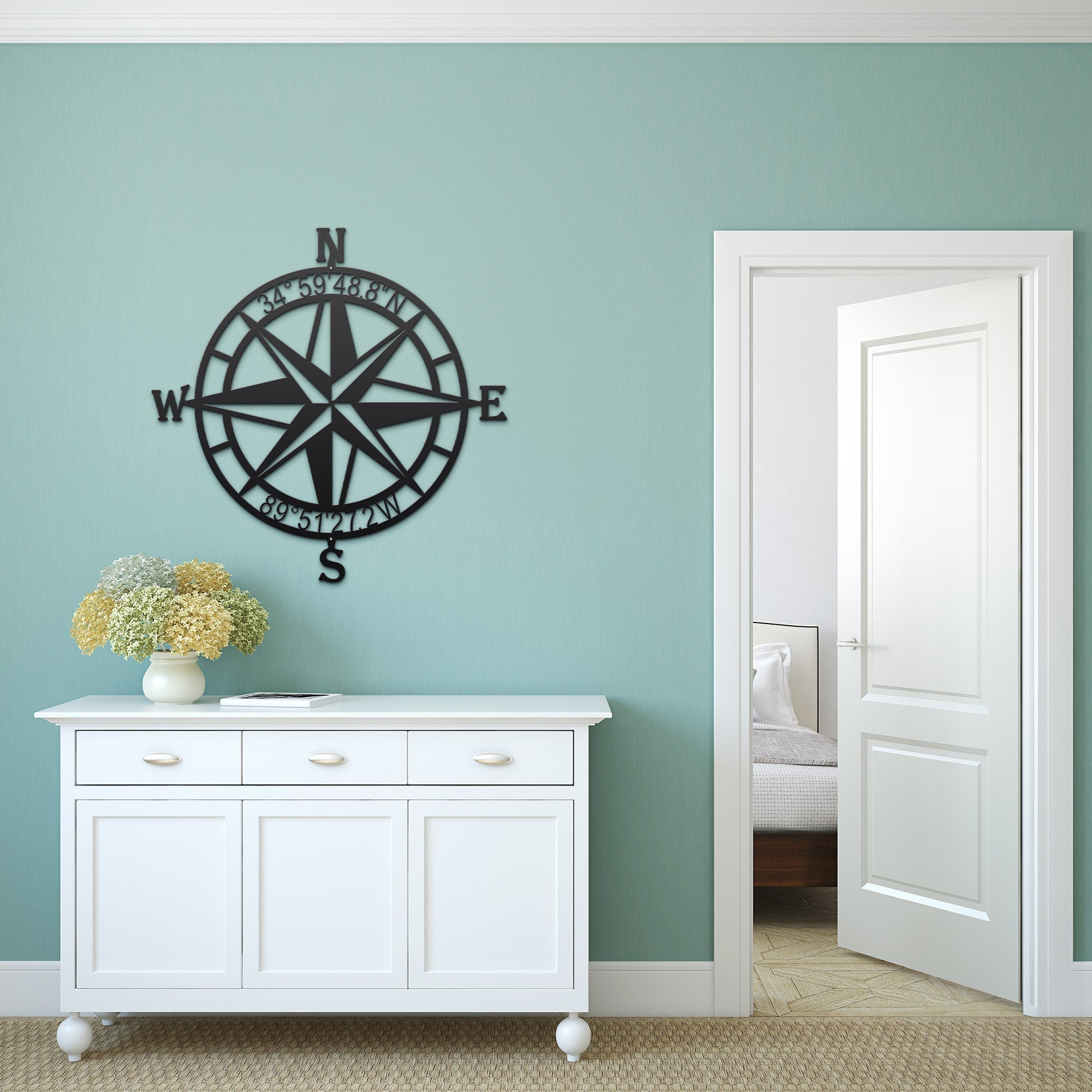 Decorative nautical compass rose metal wall art on light blue wall above white cabinet with flowers, coastal décor, HouseSensationsArt