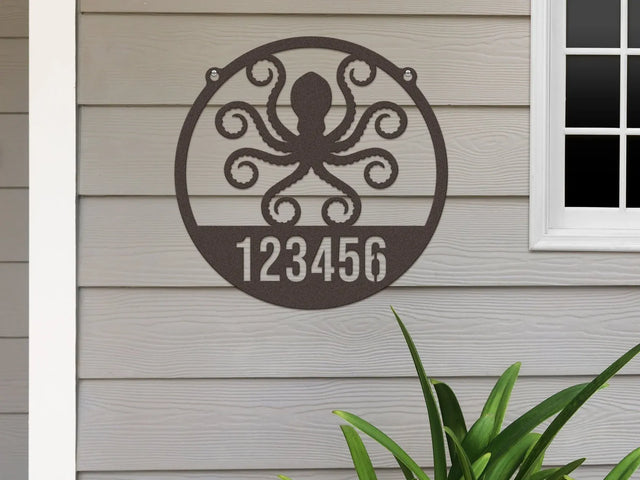Round oil rubbed bronze Address Sign with house number '123456' and octopus design, mounted on door wall.