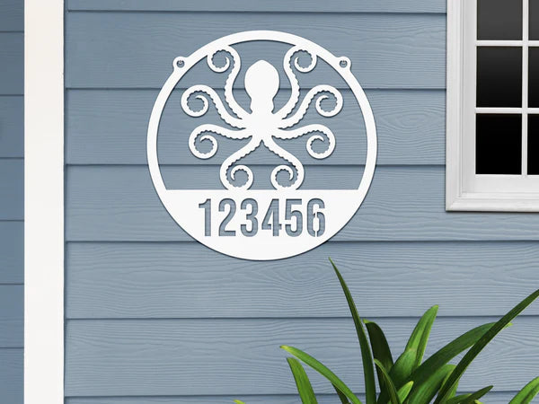 Round white Address Sign with house number '123456' and octopus design, mounted on door wall.
