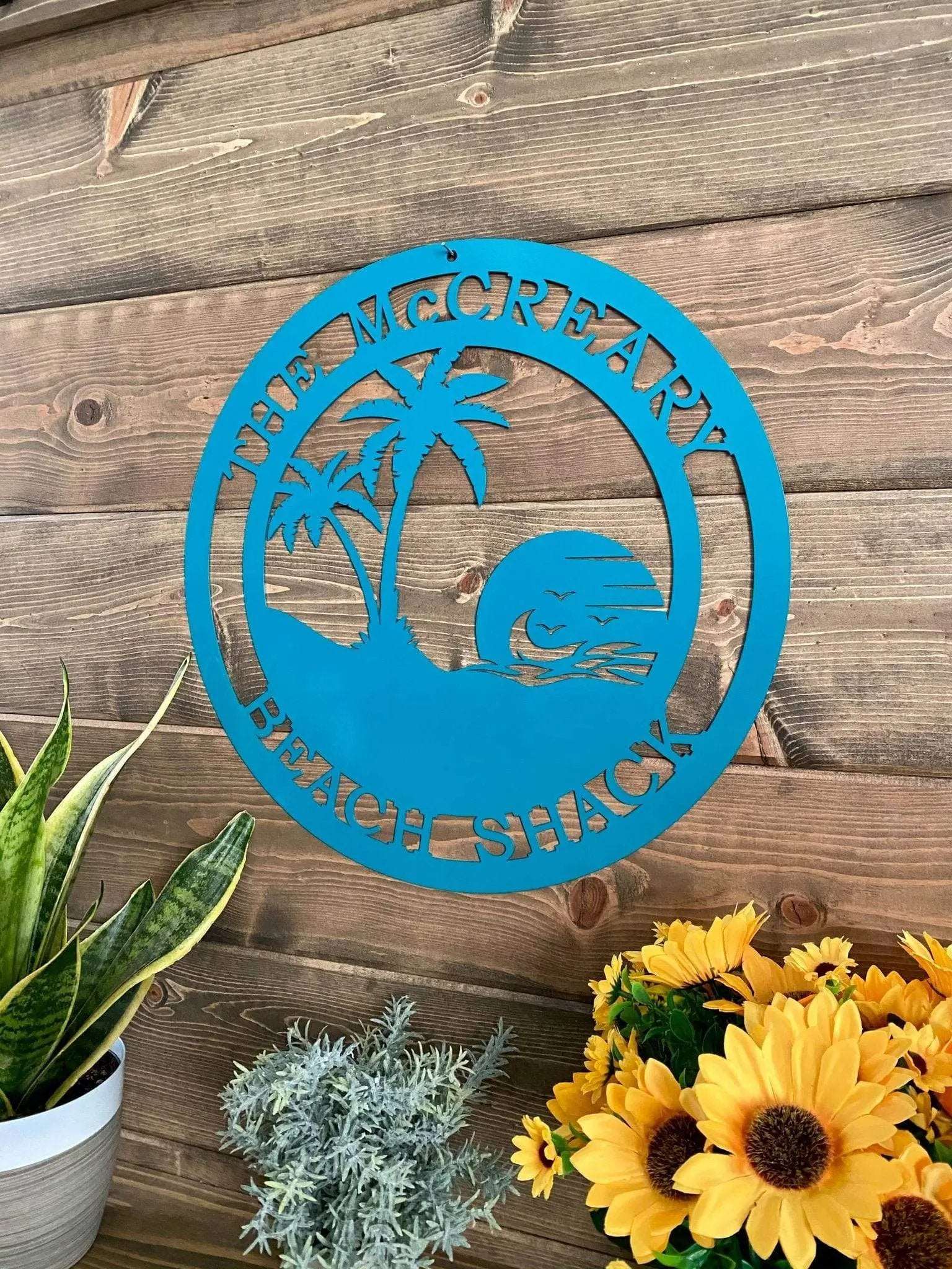 Palm tree and sunset-themed metal sign with name and date personalization for beach retreat