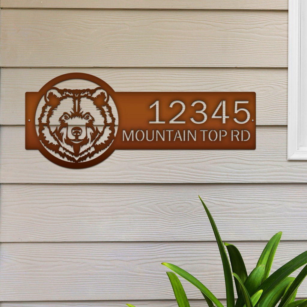Personalized brown bear cabin house number sign, rustic metal décor with bear head design on wooden wall near window