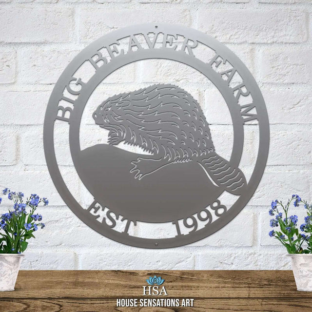 Polished chrome laser cut ranch sign with beaver silhouette, “BIG BEAVER FARM EST 1998” text; rustic outdoor decor.