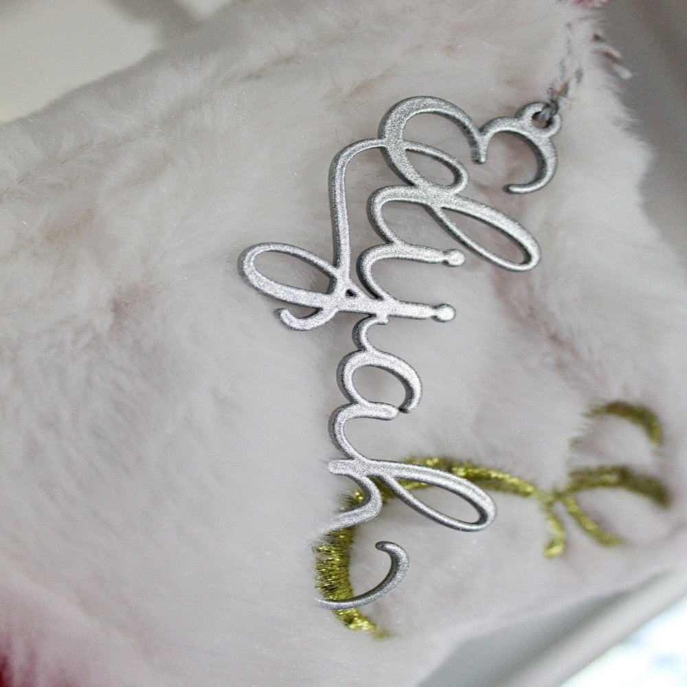 Silver decorative item with Happy text displayed on white surface, festive or celebratory décor piece for home display or gift decoration