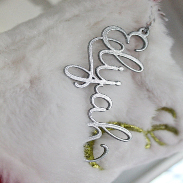 Silver decorative item with Happy text displayed on white surface, festive or celebratory décor piece for home display or gift decoration