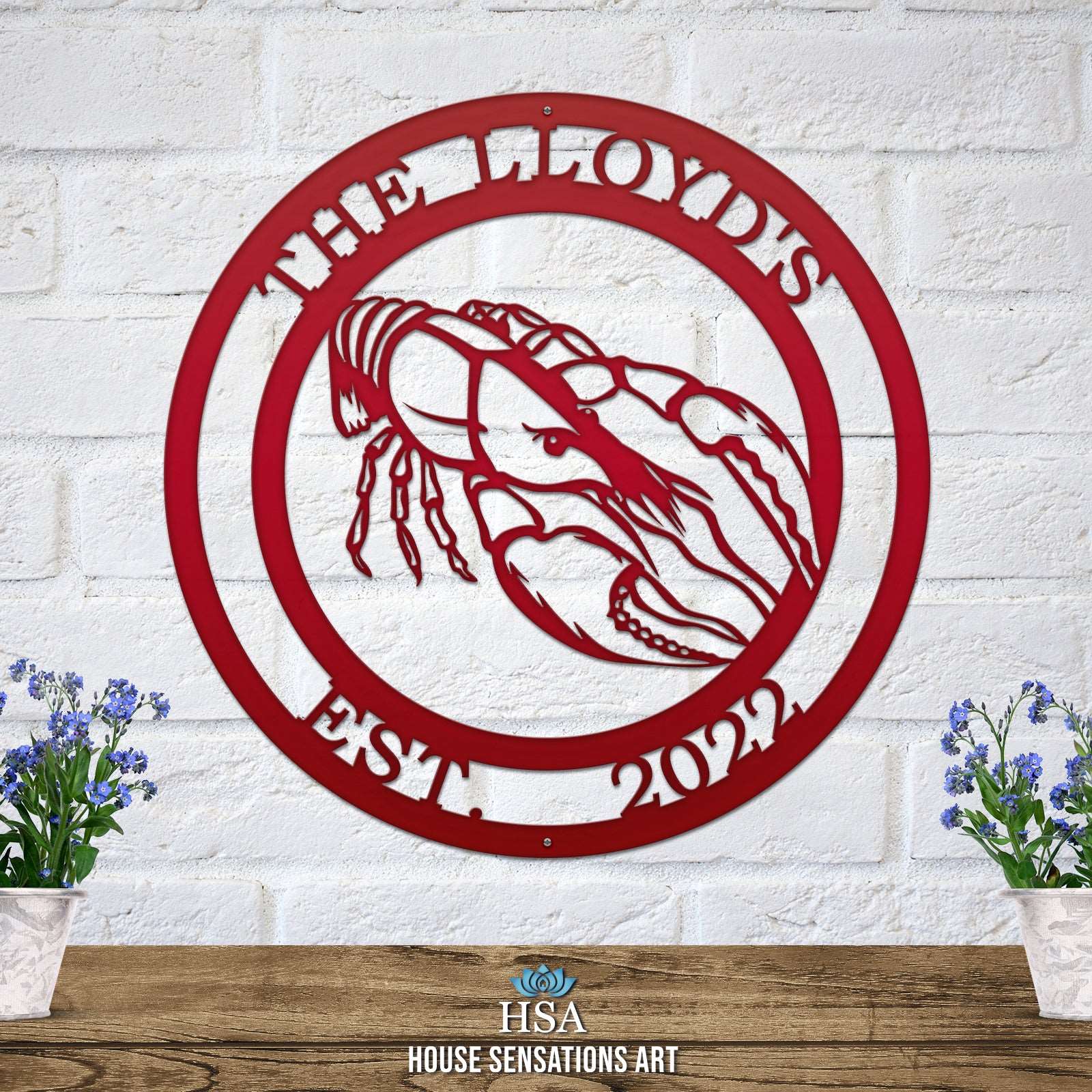 A deep red custom laser cut metal sign showing crawfish in center, with “THE LLYOD’S EST 2022” text, outdoor nautical decor.