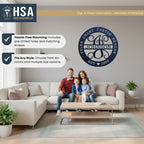 Living room scene with family on a couch, showcasing personalized decorative metal wall art with HSA branding, highlighting custom family name signage for home décor.