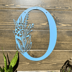 Personalized floral monogram metal door sign “O” in powder blue with floral design on wood background, farmhouse entry décor, custom front porch wall art