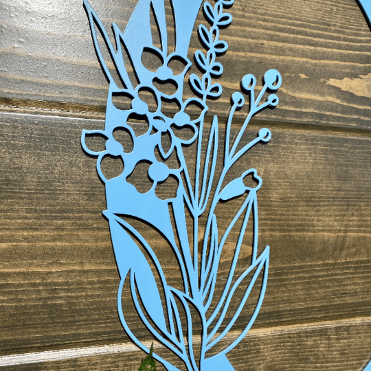 Personalized floral monogram metal door sign with powder blue flower design on wood background, custom farmhouse entry décor, decorative wall art