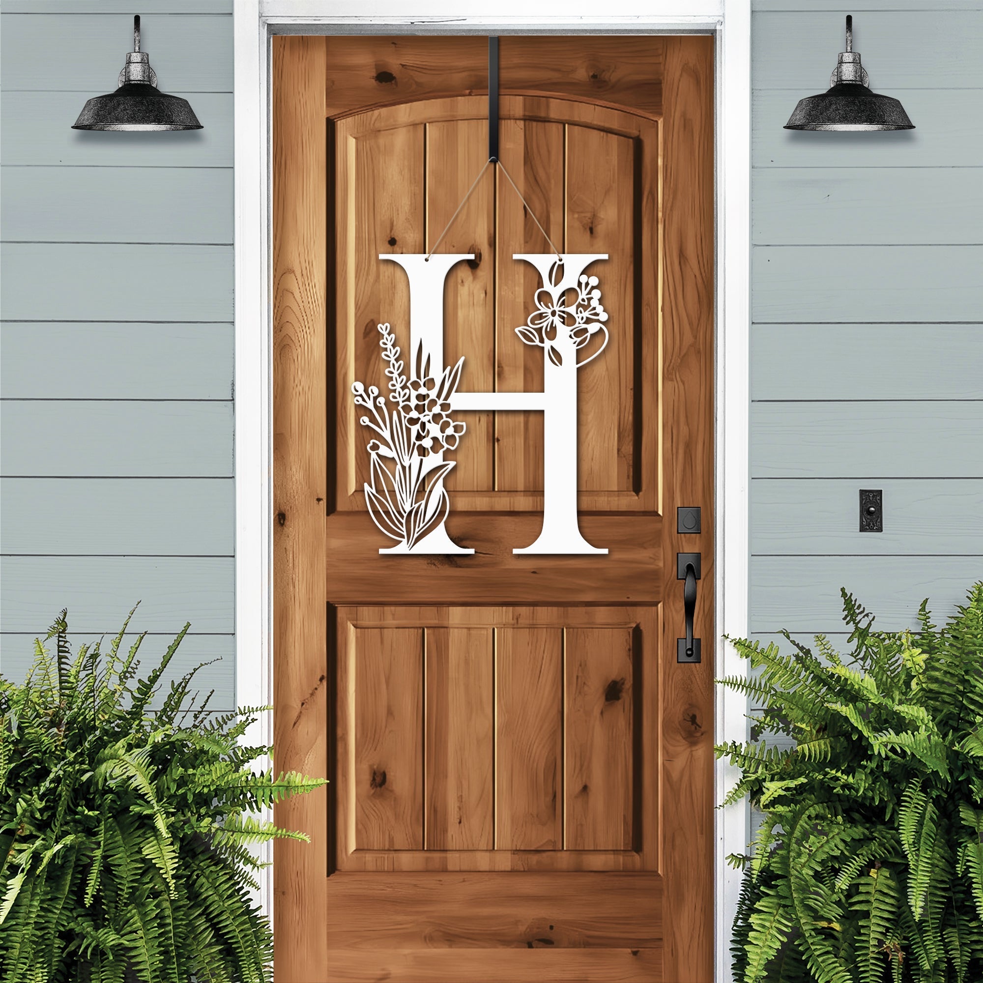 Personalized floral monogram metal door sign “H” on cream wood door, farmhouse entry décor, custom front porch wall art, light blue exterior background