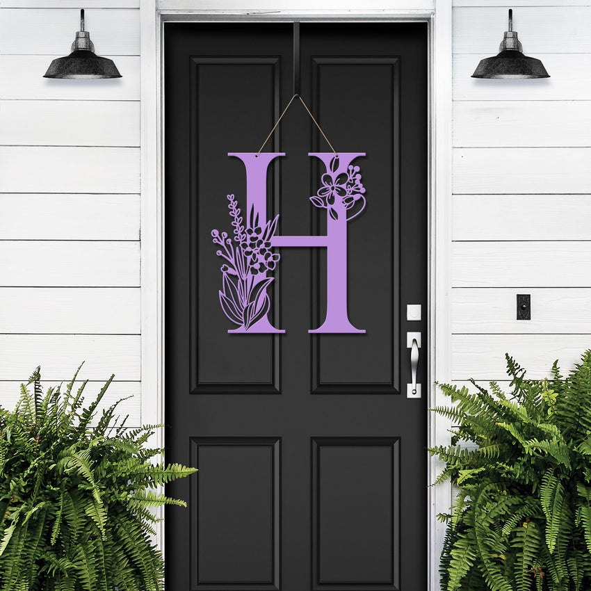 Personalized floral monogram metal door sign “H” in violet on black door, custom farmhouse entry décor, front porch wall art, white wall background
