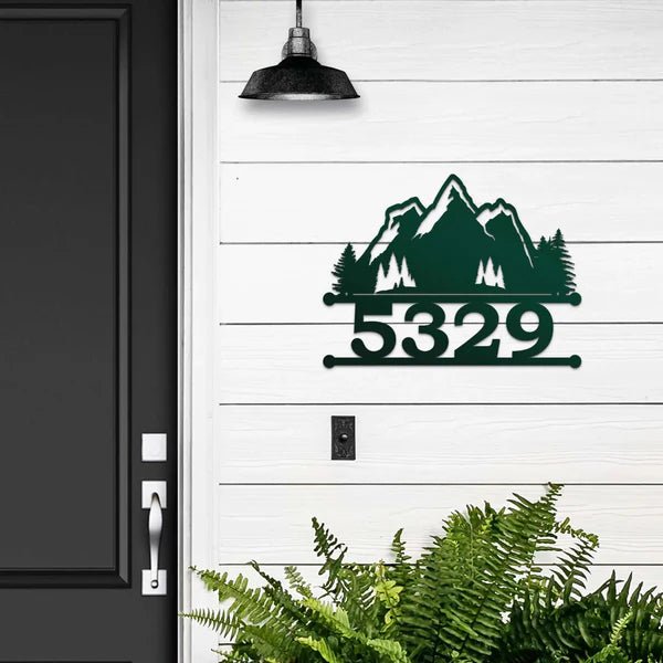 Personalized metal house number sign with mountain design mounted on a white door for outdoor curb appeal, HouseSensationsArt