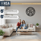 Living room scene with family on a couch, showcasing a customizable initial and family name metal wall décor for weddings or anniversaries, featuring HSA House Sensations Art branding, ideal for indoor home décor and personalized gifts.