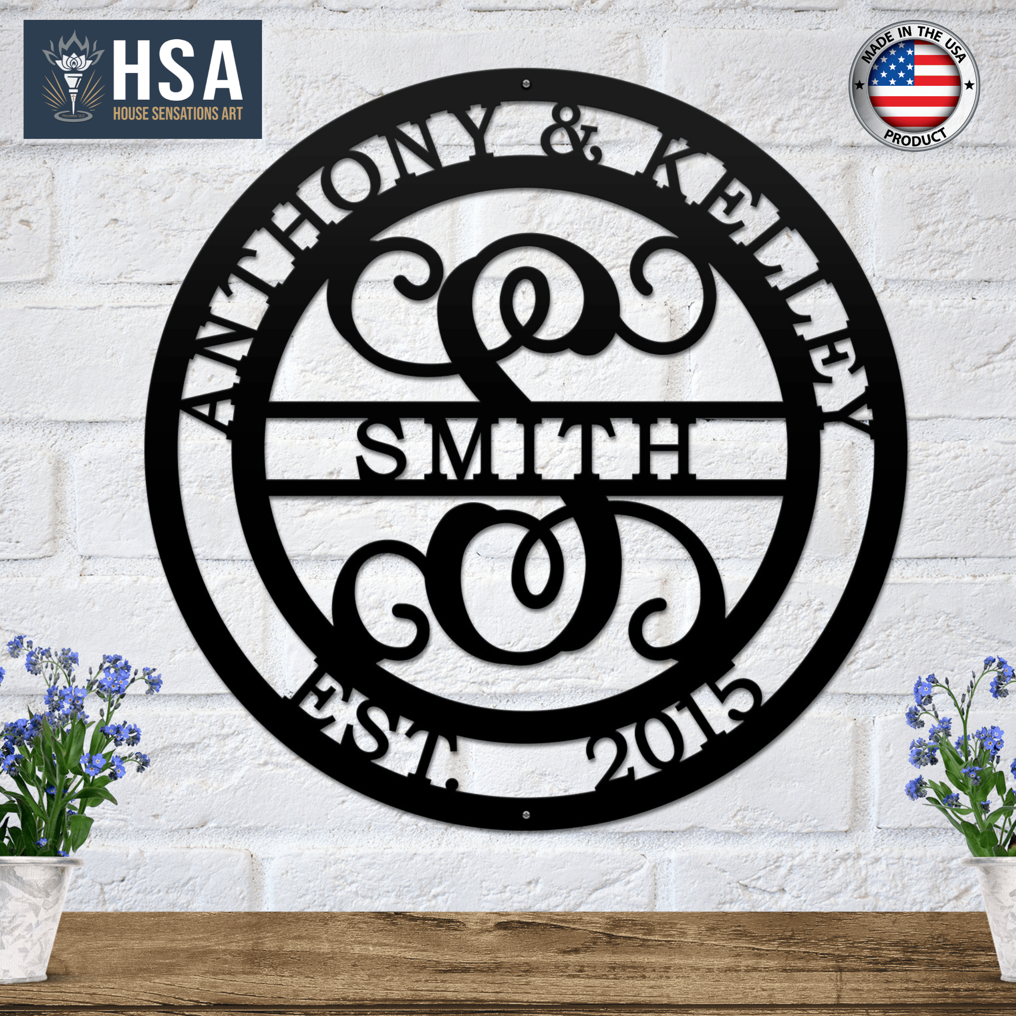 Personalized initial and family name metal wall décor for weddings or home décor, featuring “Anthony & Kelley Smith” on a white brick wall, ideal for indoor displays and custom anniversary or wedding gifts by HSA House Sensations Art.