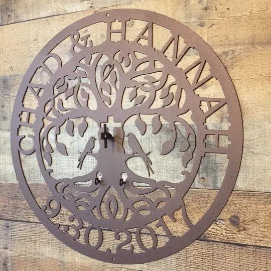 Personalized metal wall clock with cut-out design and engraved text, custom metal wall art on wood backdrop, modern rustic décor, powder coated sign