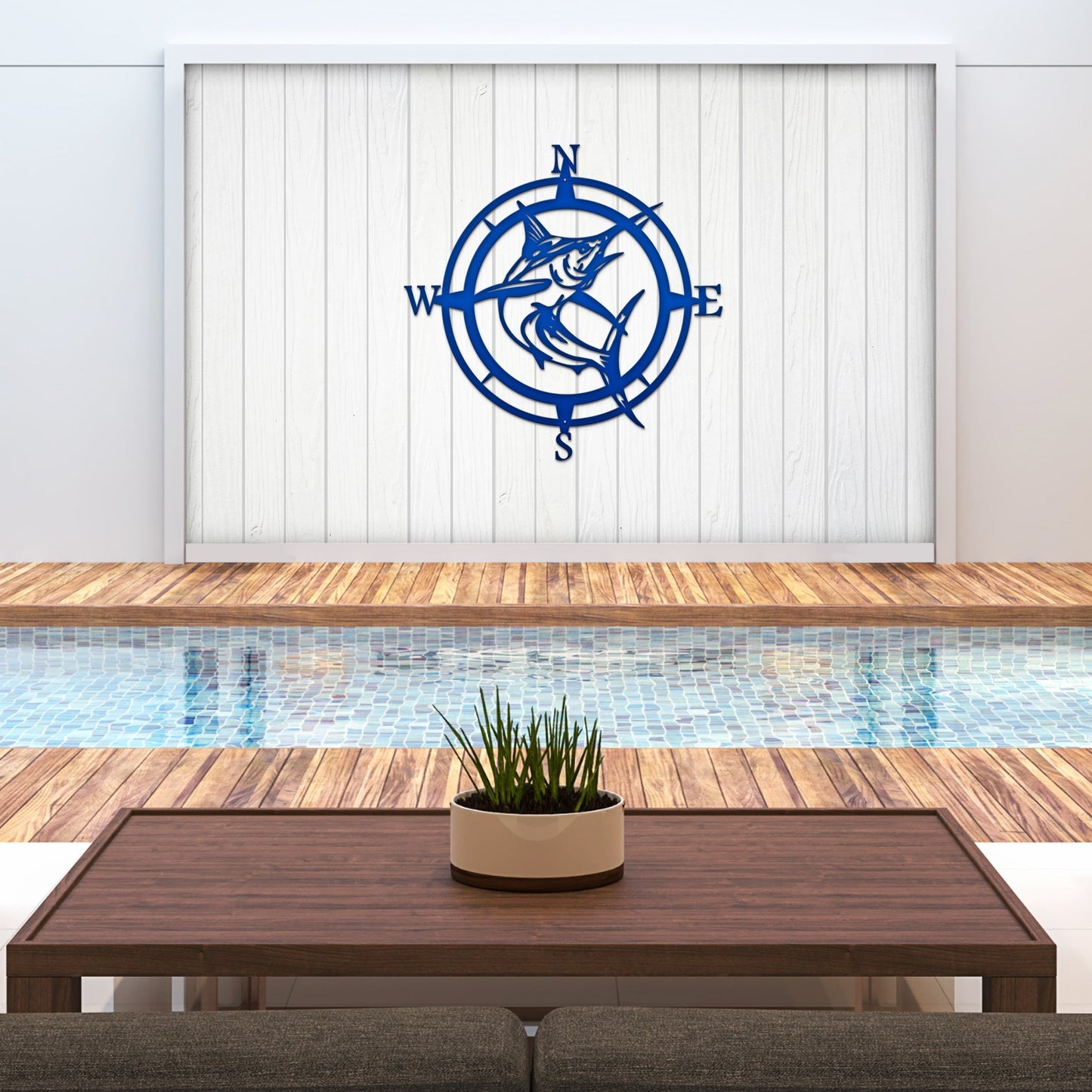 Decorative metal compass wall art above pool with wooden deck, nautical outdoor décor, custom home exterior accent