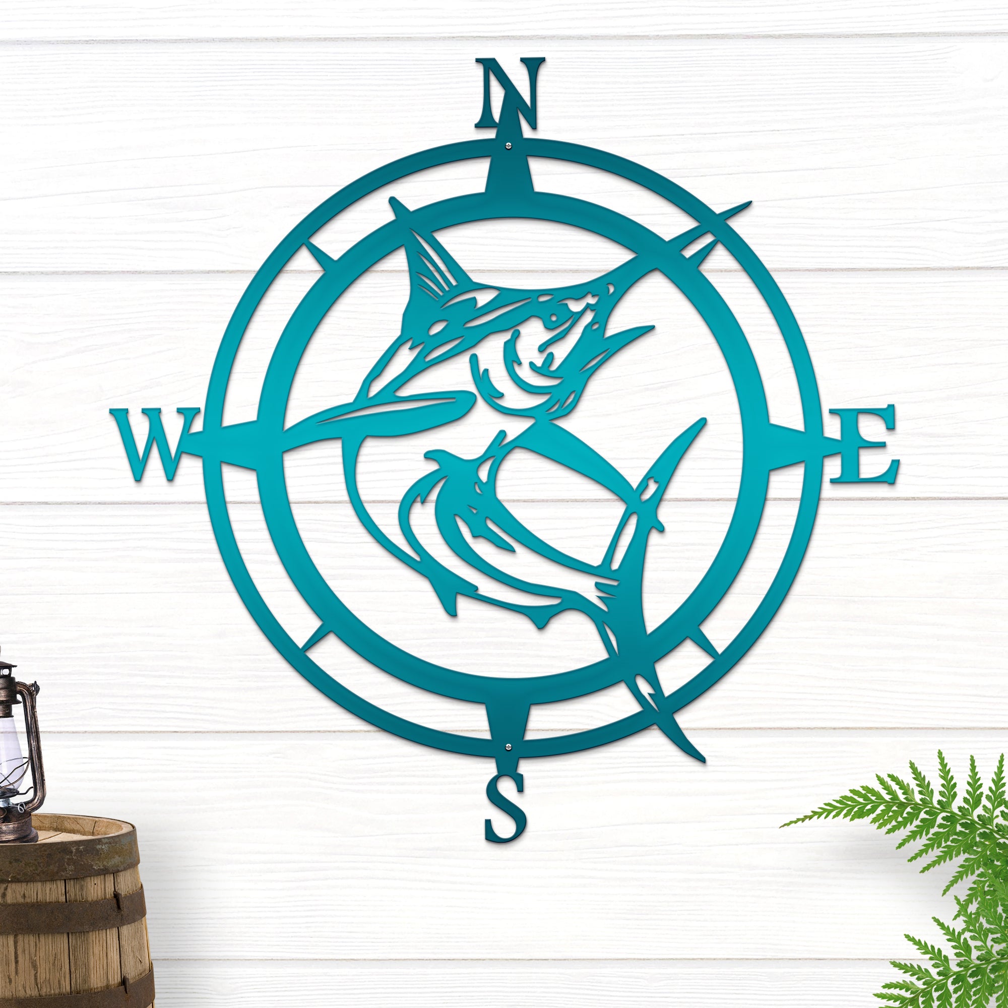 Teal compass wall decor with fish silhouettes on white wooden background, nautical metal wall art, decorative home exterior accent