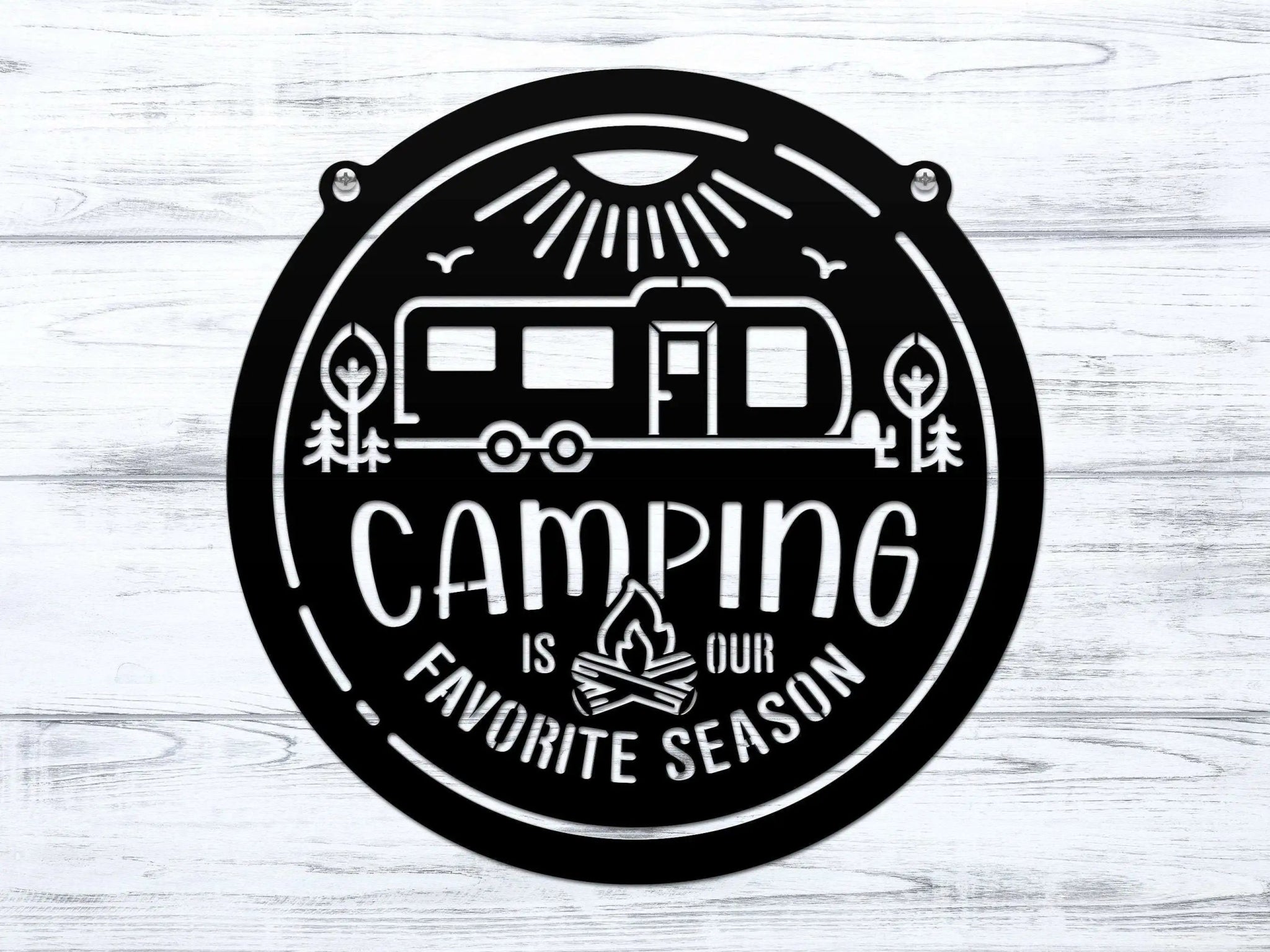 Circular metal sign featuring a camping-themed design with text, displayed on a white wooden background, highlighting rustic style and durable decorative craftsmanship.