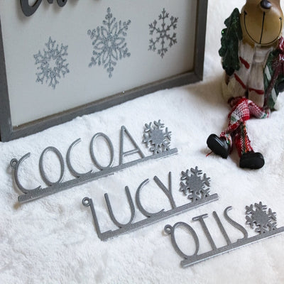 Personalized snowflake metal name tags set, custom Christmas table décor place settings, laser cut holiday nameplates on snowy background, HouseSensationsArt