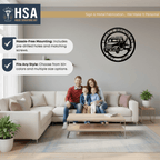 Family sitting on a couch in a living room with a metal wall art piece featuring a truck design displayed on the wall, creating a warm and inviting home décor scene.