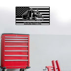 Metal wall art featuring truck design and American flag on white wall, displayed above red toolbox, patriotic decorative signage for garage or workshop décor