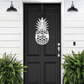 Black front door with pineapple hello metal sign decal, white wall exterior with green plants, tropical farmhouse entry décor, custom powder coated welcome wall art sign