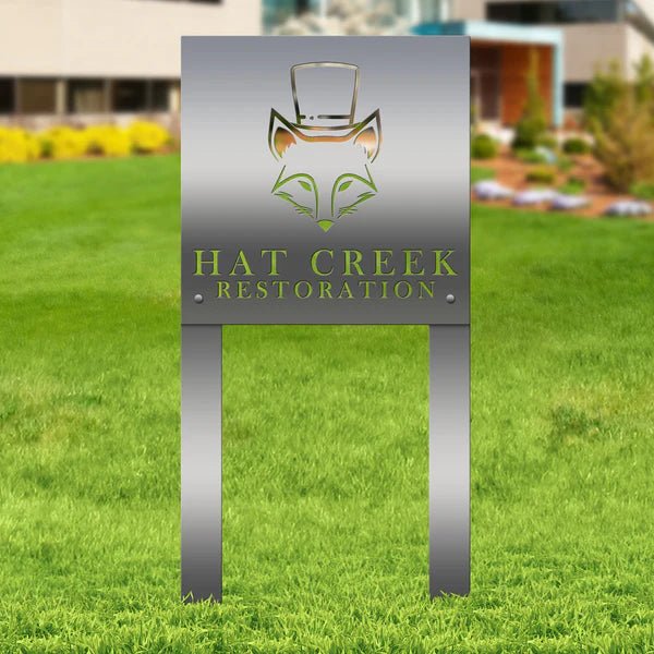 Custom metal sign with 'Hat Creek Restoration' logo on grassy outdoor background, personalized laser-cut design for business branding and decorative outdoor display